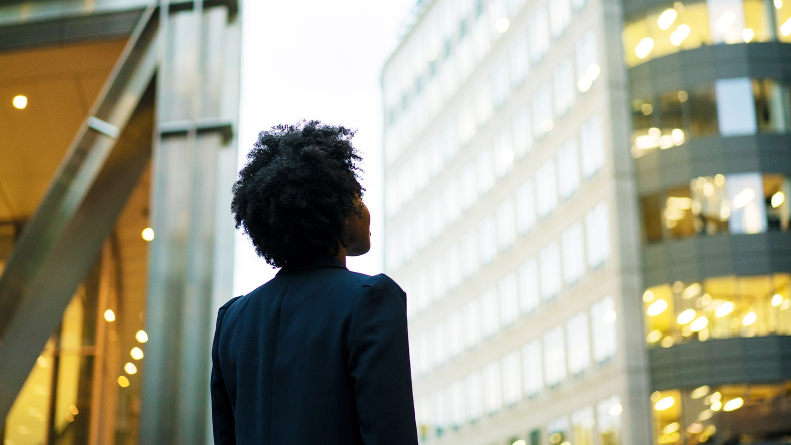 Woman looking up at a building.